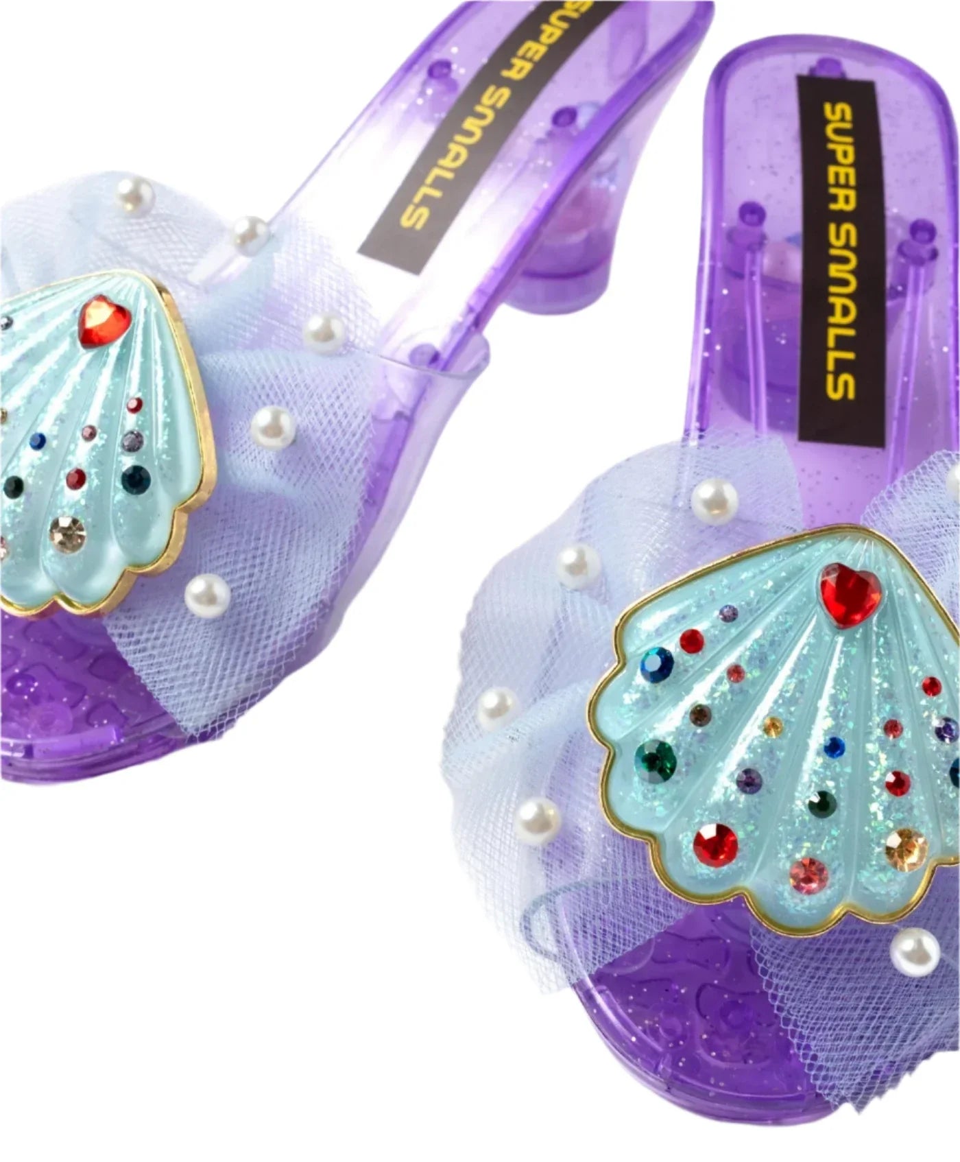The Mermaid Dreams Play Shoes by Super Smalls are purple heeled children's sandals with tulle, faux pearls, and gem seashell heels—perfect for kids who love magical mermaid dress up.