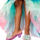 A child wears Super Smalls' Mermaid Dreams Play Shoes—pastel, flowing, and adorned with translucent purple gem seashells—for magical mermaid dress-up adventures.
