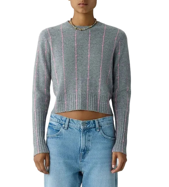 Grey shrunken cashmere Shrunken Checker Crew sweater with vertical pink pinstripes worn with light-wash blue jeans.