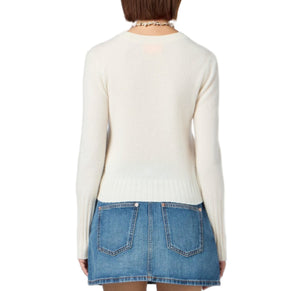 A person is shown from the back wearing the Guest in Residence Shrunken Crew Cashmere Sweater and a blue denim mini skirt against a plain white background.