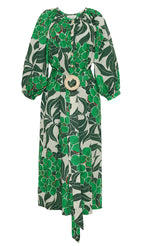 The Cara Cara Simone Dress highlights a green floral print with long sleeves and a button-down front featuring crochet-covered buttons. A wide belt with a large circular buckle adds the final touch to this elegant design.