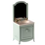 A small and elegant Maileg Sink Dresser for your mouse, featuring a mint green cabinet, a gold faucet, an attached mirror, and a cleverly hidden small closet under the sink.