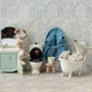 The Maileg Sink Dresser, Mouse - Mint by Maileg features a delightful miniature bathroom scene with toy mice: one relaxing in a bathtub, another fishing in a toilet, a third peering into a mirror at the sink, and a fourth wearing a bathrobe. The set includes various charming bathroom accessories and boasts a small closet under the sink for added storage.