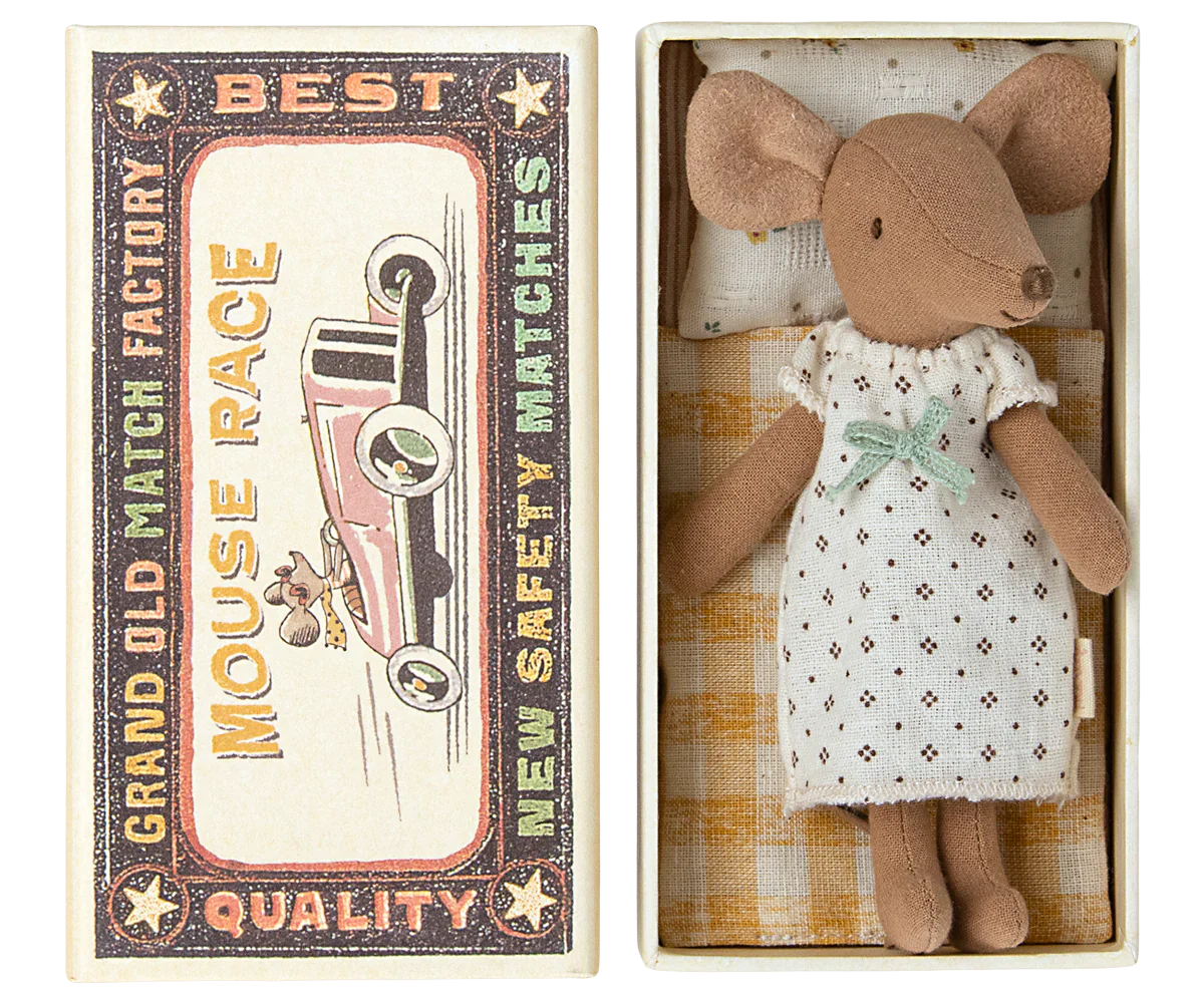 A Maileg Big Sister Mouse in a nightgown is placed inside an open matchbox bed labeled “Mouse Race - Best Quality.” The matchbox, which serves as a cozy toy for kids, features an illustration of a car.