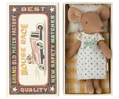 A Maileg Big Sister Mouse in a nightgown is placed inside an open matchbox bed labeled “Mouse Race - Best Quality.” The matchbox, which serves as a cozy toy for kids, features an illustration of a car.