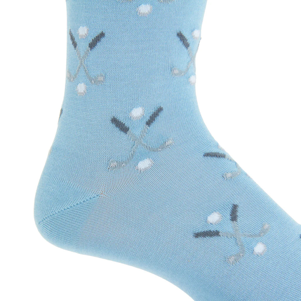 A sky blue Dapper Classics sock with steel golf club and ball motifs, made from cotton, featuring a linked toe and mid-calf length.
