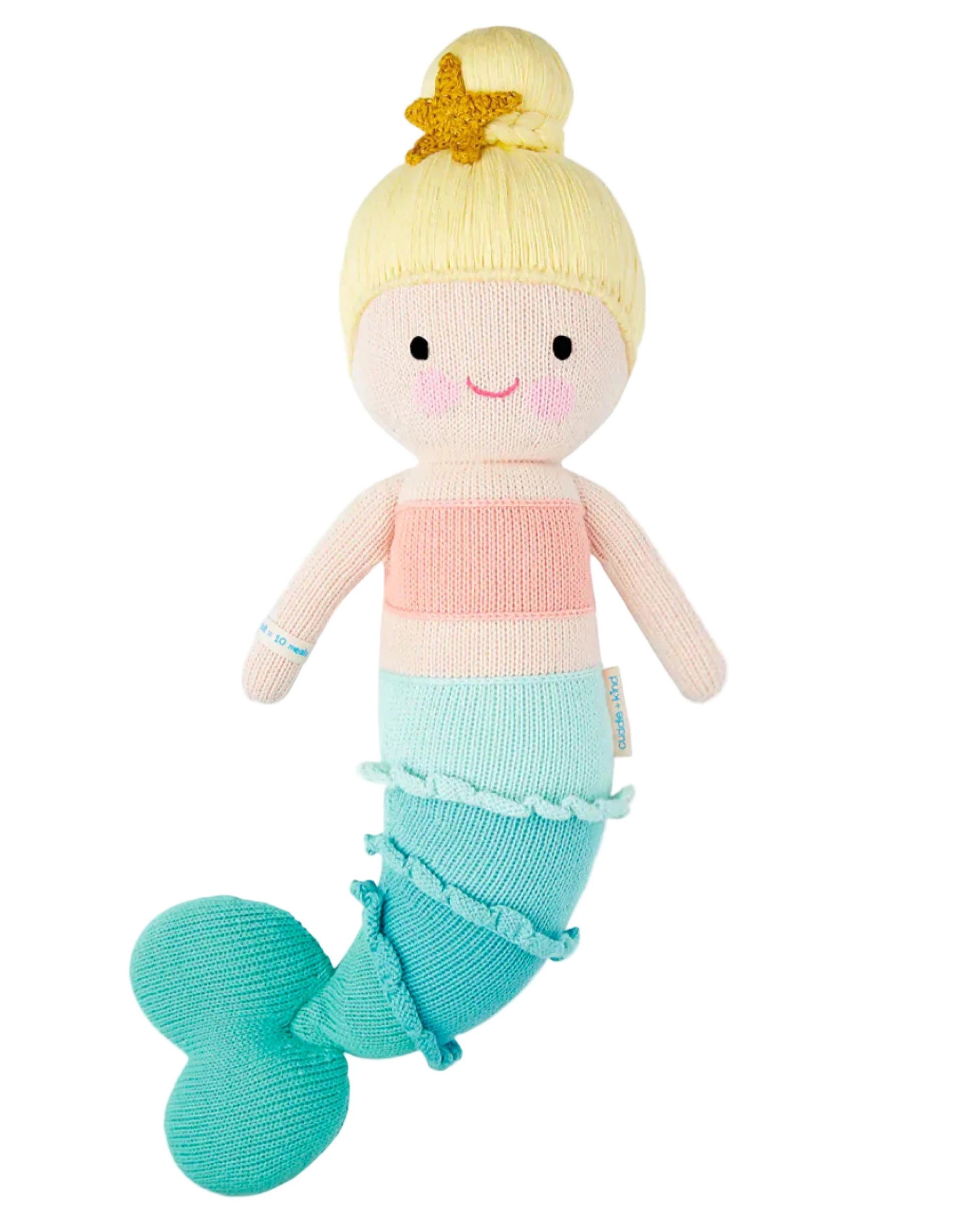 Skye the Mermaid by Cuddle + Kind is a 20" knitted plush with blonde hair in a bun, starfish hair accessory, pink top, and blue-green tail—an adorable addition to any seashell collection or ocean-themed playtime.