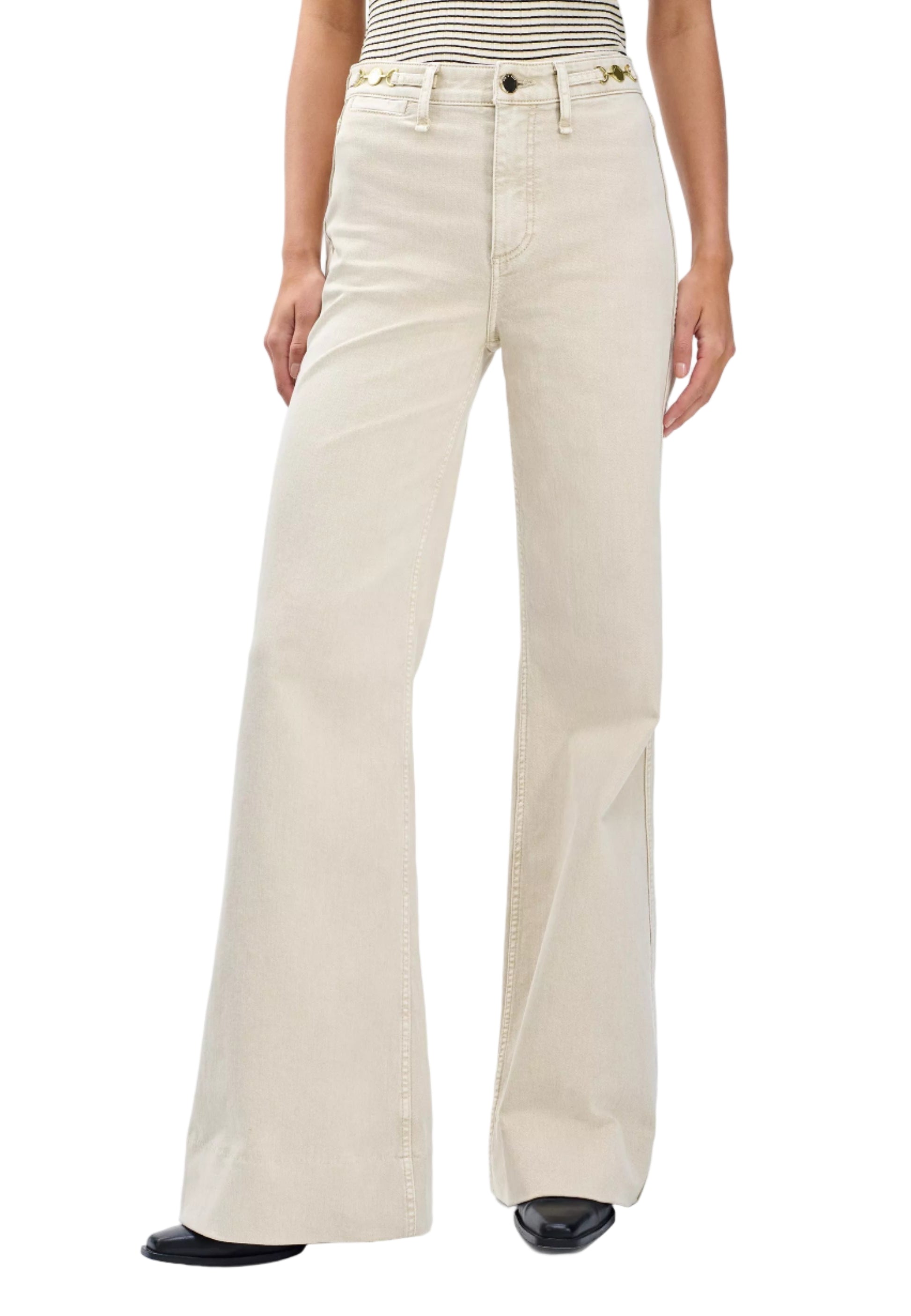 A person wears Rag & Bone Skylar High Rise Trouser Jeans in vintage stretch denim with a striped sleeveless top and black pointed shoes.