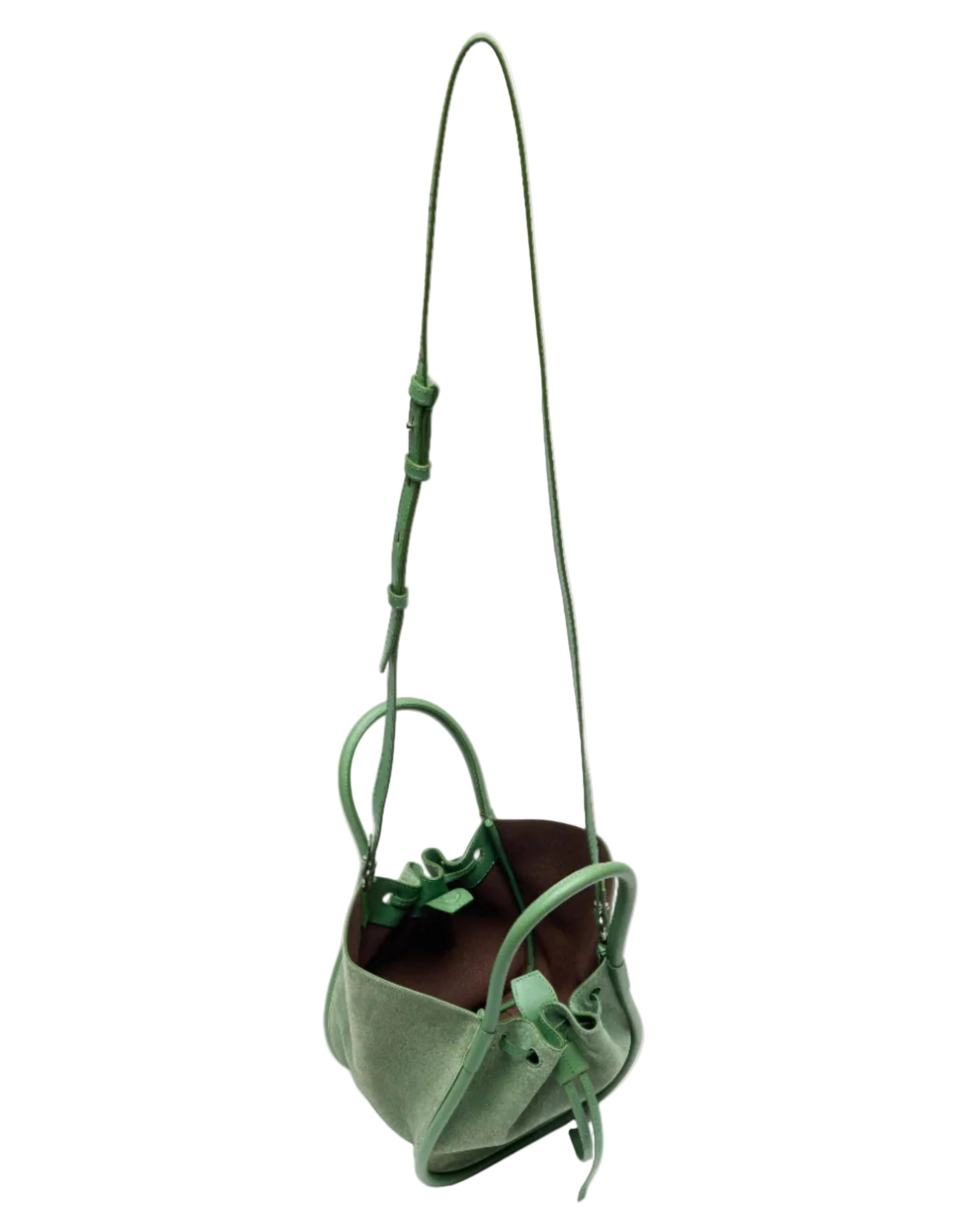 The Proenza Schouler Small Ruched Soft Suede Tote features soft green suede, an adjustable shoulder strap, two handles, a brown interior, decorative side knots, and a sculptural silhouette for stylish flair.