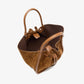 The Small Ruched Soft Suede Tote by Proenza Schouler is crafted in brown suede and leather, showcasing a sculptural silhouette with a top handle, drawstring closure, and dark interior lining. Photographed against a white background.