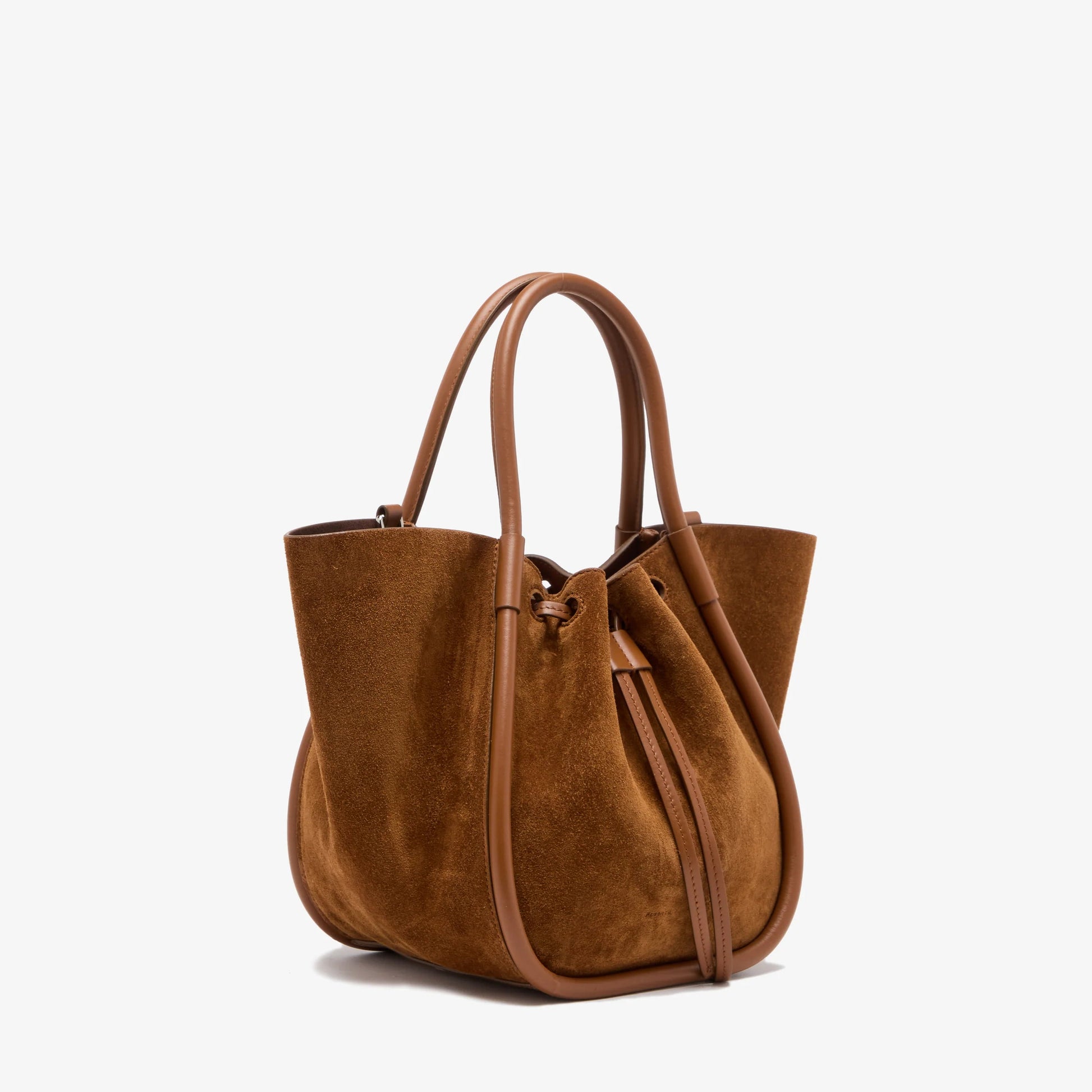 The Small Ruched Soft Suede Tote by Proenza Schouler, crafted in brown suede with leather handles and a drawstring detail, features a sculptural silhouette and is displayed on a plain white background.