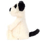 A Jellycat Bashful Black & White Puppy, Small plush toy featuring black ears, nose, and tail sits in profile against a white background.