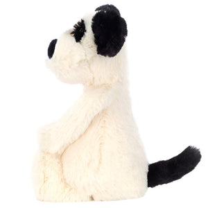 A Jellycat Bashful Black & White Puppy, Small plush toy featuring black ears, nose, and tail sits in profile against a white background.