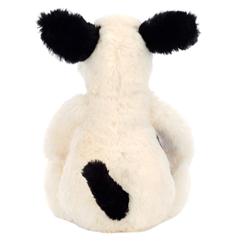 A Jellycat Bashful Black & White Puppy, Small plush toy seen from the back, featuring white fur, black ears, and a black spot on its lower back.