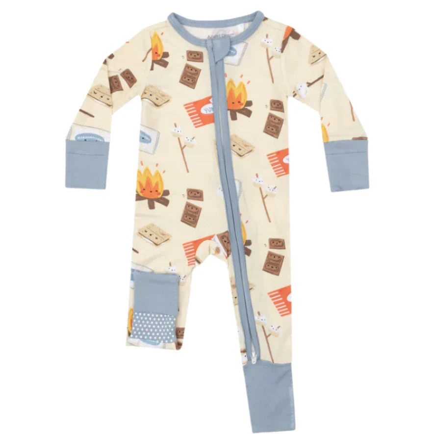 The Angel Dear Smores 2-Way Zipper Romper is a beige baby onesie made from bamboo fiber fabric, adorned with camping-themed illustrations like campfires, s'mores, and tents. It features the brand's signature prints and blue cuffs, along with a convenient 2-WAY zipper for easy changing.