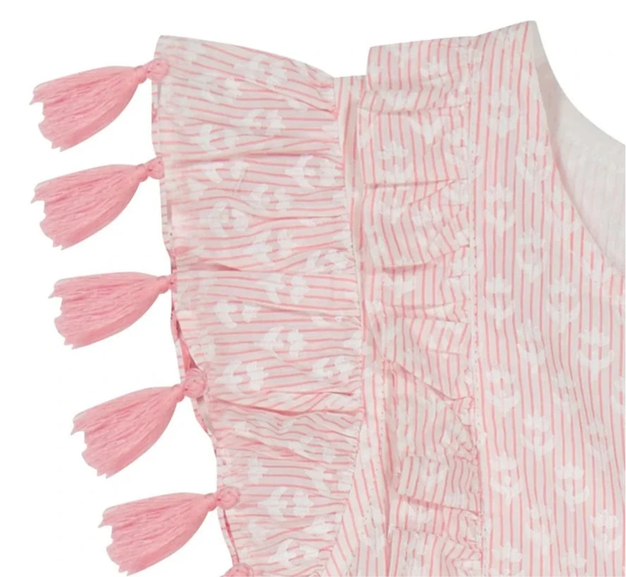 Close-up of the Mer Girls' Sophie Tassel Dress fabric, showcasing pink and white stripes, ruffles, white anchor motifs, and pink tassels along the edge.