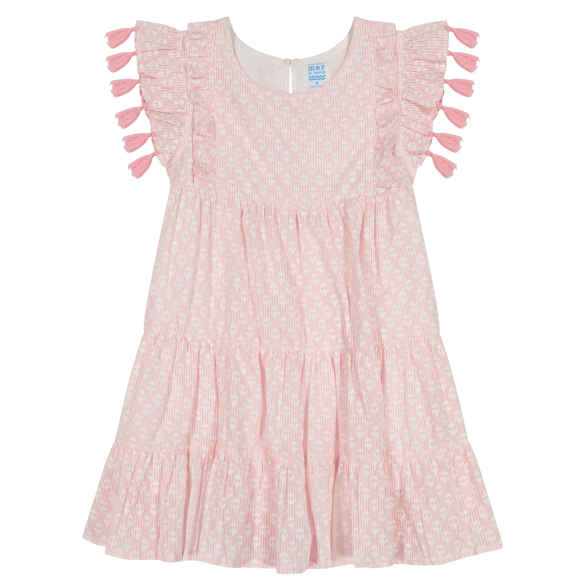 The Mer Girls' Sophie Tassel Dress showcases a pink and white pattern, ruffled sleeves, scoop neckline, tassel trim, and a tiered skirt, all displayed against a plain white background.