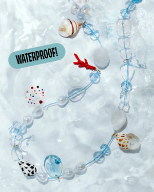 The Super Smalls Make It Splash Mini Bead Kit features a beaded necklace with waterproof beads, seashell charms, and glass accents. A bold "WATERPROOF!" label appears in black letters on a blue background.