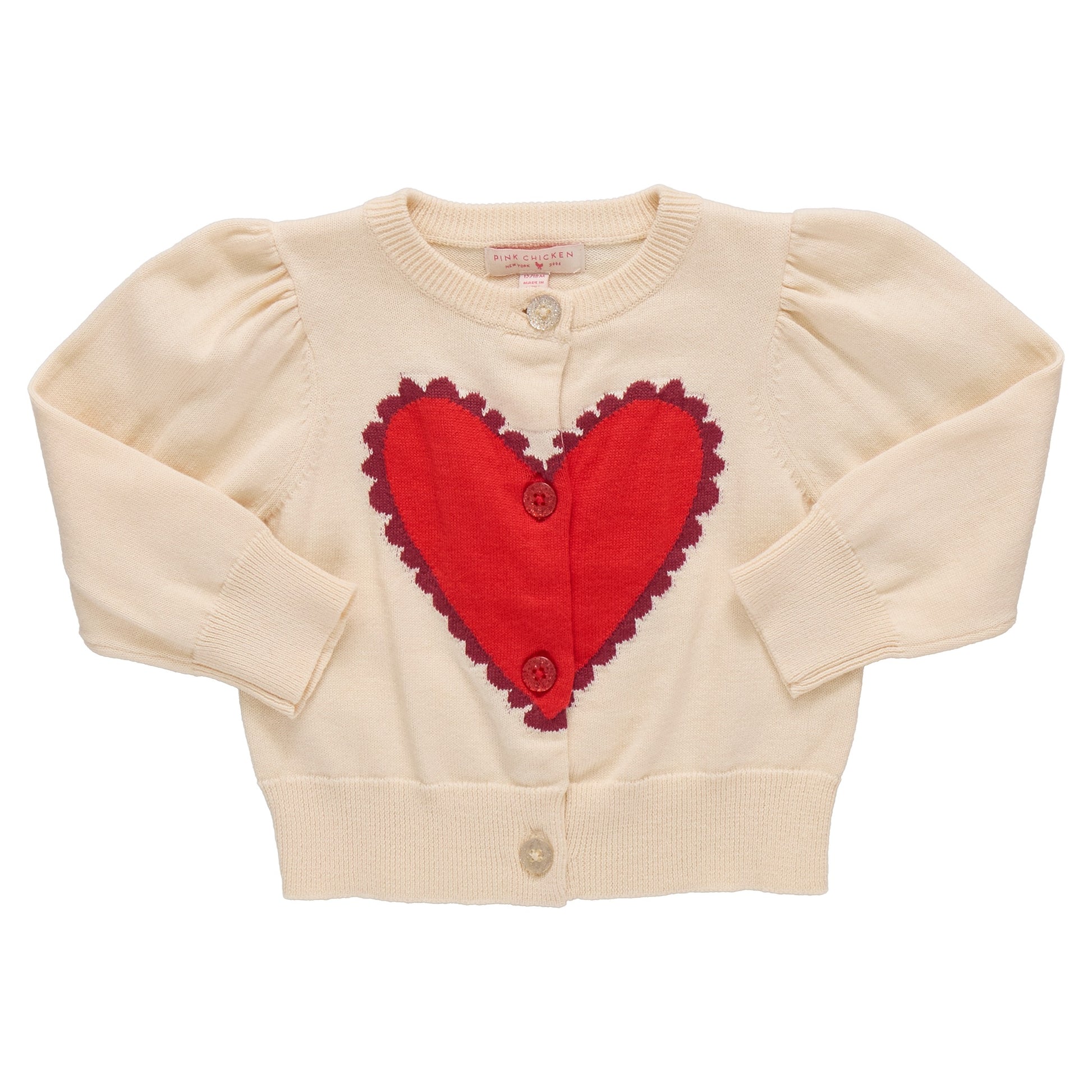 The Pink Chicken Girls' Constance Sweater is a cream cardigan with long sleeves, front buttons, and a large red heart on the chest—perfect for Valentine’s Day.