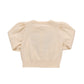 The Baby Girls' Constance Sweater by Pink Chicken is a cream-colored, short-sleeve Valentine’s Day style with puffed sleeves, shown from the back against a white background.
