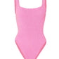 The Hunza G Square Neck Swim is a sleeveless, textured pink one-piece swimsuit made from Original Crinkle™ fabric, featuring high-cut legs and a one-size-fits-all design, shown against a white background.
