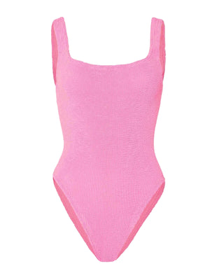 The Hunza G Square Neck Swim is a sleeveless, textured pink one-piece swimsuit made from Original Crinkle™ fabric, featuring high-cut legs and a one-size-fits-all design, shown against a white background.