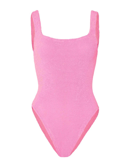 The Hunza G Square Neck Swim is a sleeveless, textured pink one-piece swimsuit made from Original Crinkle™ fabric, featuring high-cut legs and a one-size-fits-all design, shown against a white background.