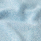 Close-up of the light blue Square Neck Swim by Hunza G, featuring crinkle fabric with small loops and subtle surface wrinkles.