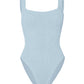 The Hunza G Square Neck Swim is a light blue one-piece crafted from signature crinkle fabric, featuring wide shoulder straps and a square neckline, shown against a plain white background.