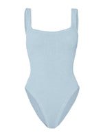 The Hunza G Square Neck Swim is a light blue one-piece crafted from signature crinkle fabric, featuring wide shoulder straps and a square neckline, shown against a plain white background.