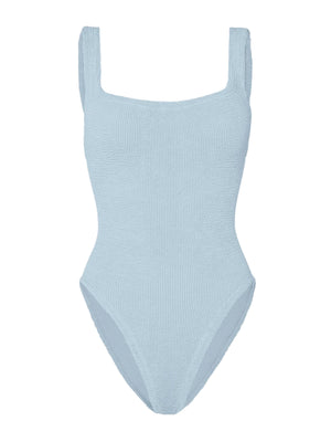 The Hunza G Square Neck Swim is a light blue one-piece crafted from signature crinkle fabric, featuring wide shoulder straps and a square neckline, shown against a plain white background.