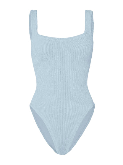 The Hunza G Square Neck Swim is a light blue one-piece crafted from signature crinkle fabric, featuring wide shoulder straps and a square neckline, shown against a plain white background.