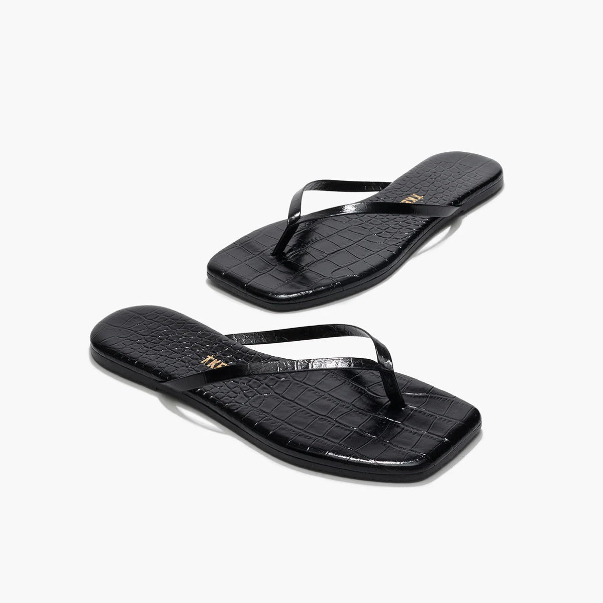 The Tkees Lily Square Toe Croc Sandal is a black, square-toe flip-flop with crocodile-embossed leather, shown on a white background.