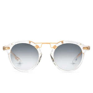Krewe St. Louis Mirrored Sunglasses feature clear acetate round frames, a gold metal bridge, and a classic silhouette with grey gradient lenses, all displayed against a white background.
