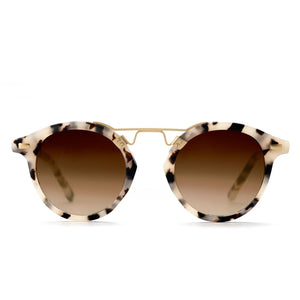 The Krewe St. Louis Sunglasses feature an iconic round silhouette, tortoiseshell-patterned frames, gold accents, and brown gradient lenses, shown against a white background.
