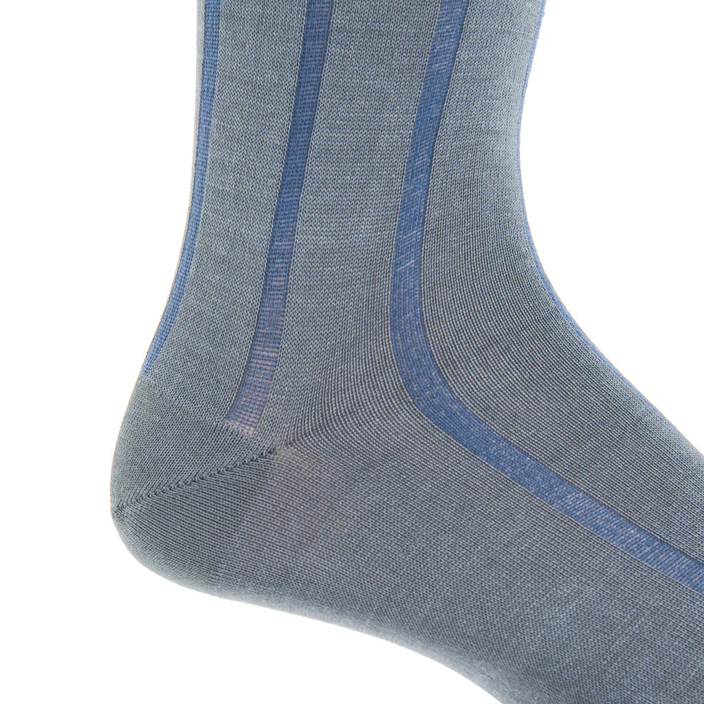 Close-up of the Dapper Classics Steel Gray with Indigo Blue Vertical Stripe Cotton Sock, linked toe, mid-calf, shown on a foot against a white background.