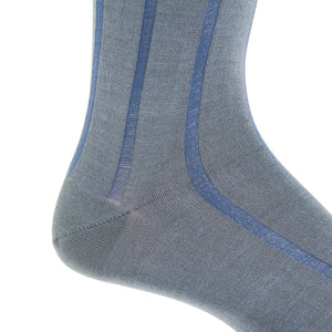 Close-up of the Dapper Classics Steel Gray with Indigo Blue Vertical Stripe Cotton Sock, linked toe, mid-calf, shown on a foot against a white background.