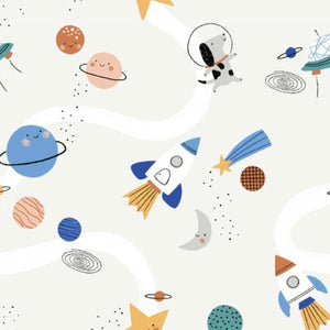 The Magnetic Me Stellar Tails Blanket by Magnetic Me boasts a space-themed design on an eco-friendly fabric, showcasing cheerful planets, rockets, comets, a moon, and an astronaut dog set against a light background made with TENCEL modal.