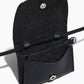 The Stella Wallet by Lie Studio is a black Italian cow leather crossbody with a flap lid, snap button closure, slim strap, and open view of the interior pocket—offering versatile style for any occasion.