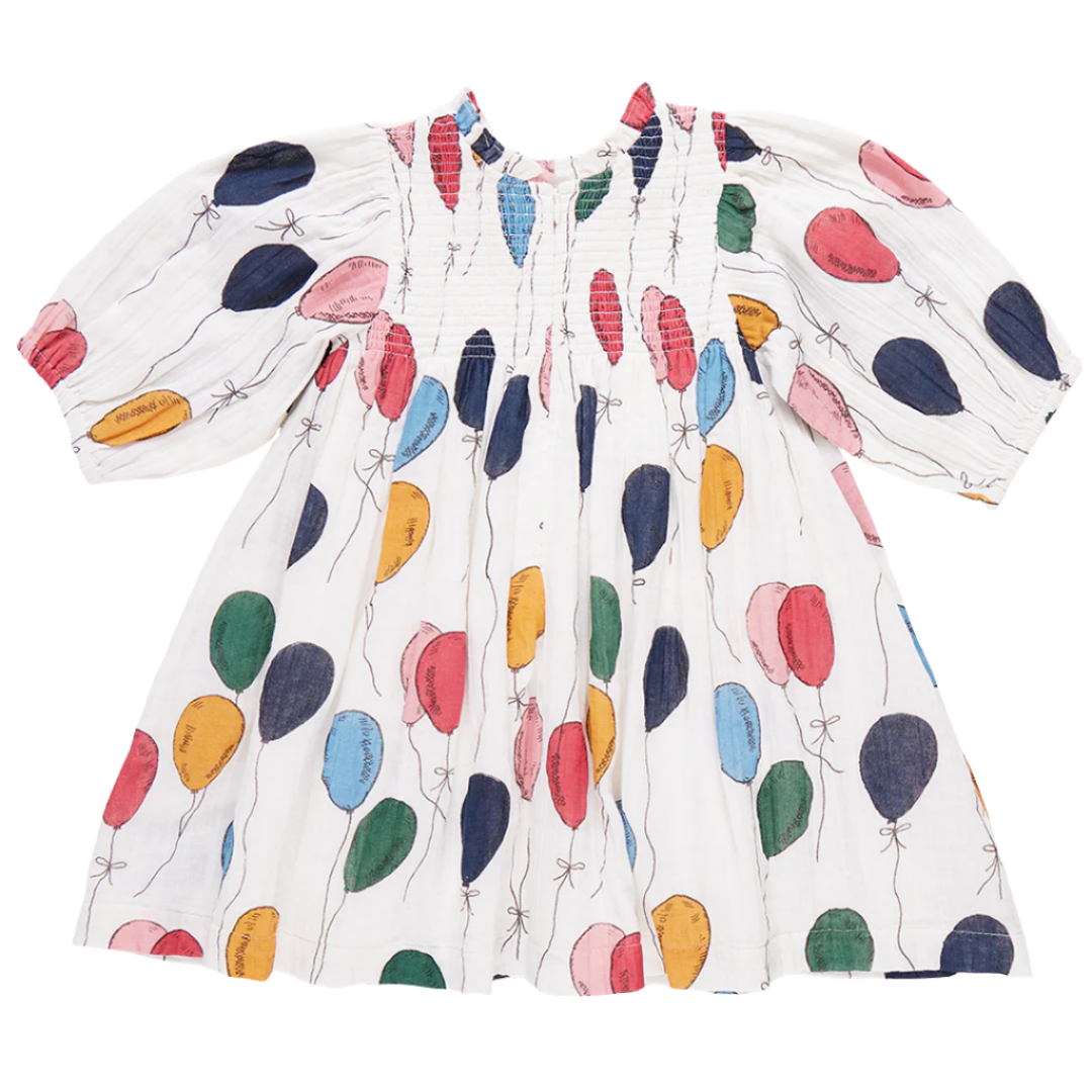 The Pink Chicken Girls' Stevie Puff Sleeve Dress by Pink Chicken features a vintage smocked front adorned with colorful balloon bunches in vibrant hues of red, blue, green, and yellow.