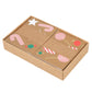 A collection of Meri Meri Gingerbread Stickers featuring festive designs like candy canes and lollipops, is neatly packaged in a larger cardboard tray, ideal for holiday decoration.