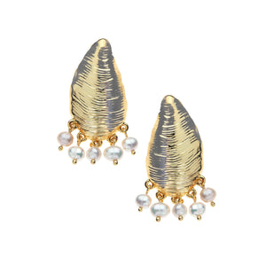 Introducing the Strong Along the Shore Earrings by Jane Win: gold and silver textured mussel shell earrings, each adorned with five small dangling white pearls. Displayed against a white background, these distinctive statement earrings are the perfect way to add elegance to any outfit.