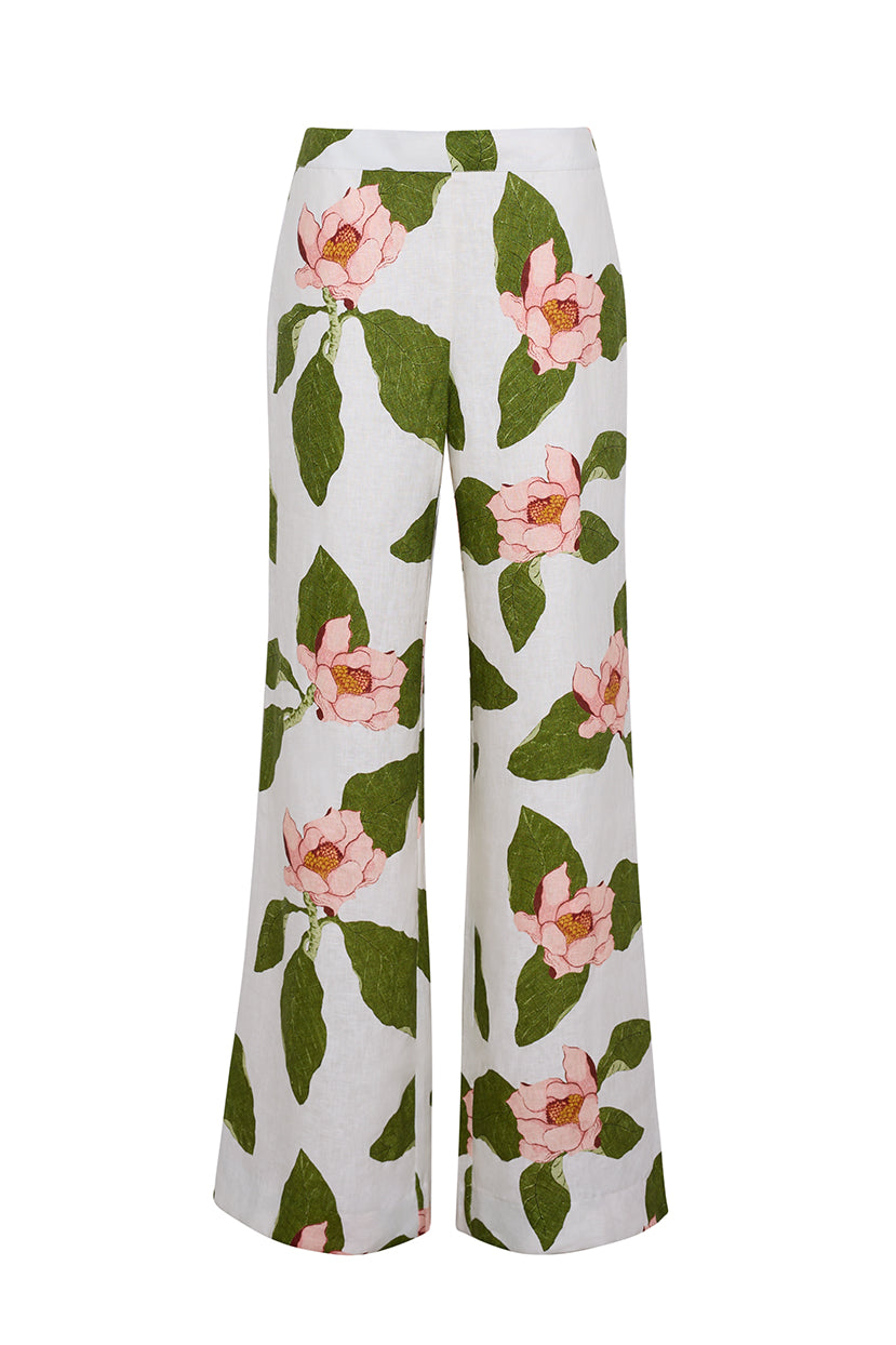 The Cara Cara Sunflower Pant is a tailored white wide-leg style showcasing a large pink floral and green leaf print.