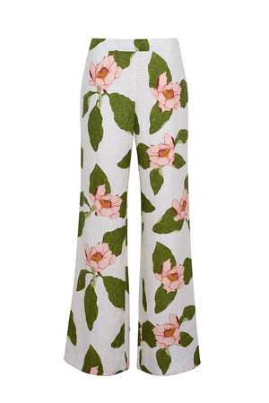 The Cara Cara Sunflower Pant is a tailored white wide-leg style showcasing a large pink floral and green leaf print.