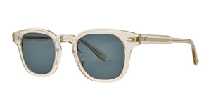 The Garrett Leight Sherwood Sunglasses feature clear frames made from blue smoke-cured cellulose acetate, dark gray lenses, and a compact square shape with slender arms. Their minimalist design offers essential UV protection.