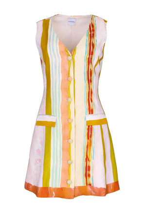 The Suni Dress by Hunter Bell NYC is a sleeveless, mini linen-rayon dress with vertical stripes in yellow, orange, pink, and blue. It features a button-down front, two front pockets, and a flattering V-neckline.