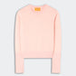 The Sunwash Shrunken Crew by Guest in Residence is a light pink cotton-cashmere crewneck sweater with ribbed cuffs, hem, and collar, shown flat against a plain light gray background—an ideal lightweight layer for effortless summer style.