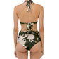 A woman is seen from the back wearing the Agua By Aguabendita Marimar Top and Vaiven Bottom Bikini, a dark green floral halter set with tie closures and high-waisted bottoms, made from recycled polyester.