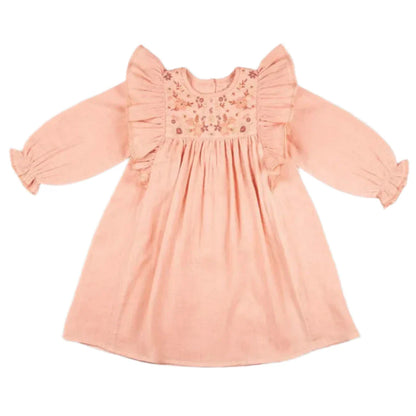 The Early Sunday Suzanne Dress is a peach-colored, long-sleeve creation made from cotton double gauze. It features exquisite floral embroidery and charming ruffle details on the shoulders and cuffs.