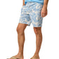 A man in a light blue shirt and Johnnie-O Salty Dogs Swim Trunks stands with one hand in his pocket, rocking casual flip-flops.